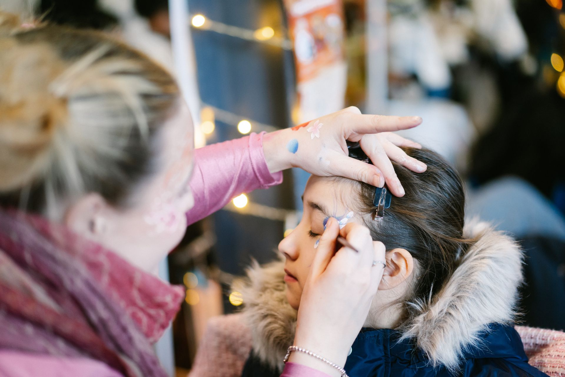 A child with a beautiful tiger face paint design